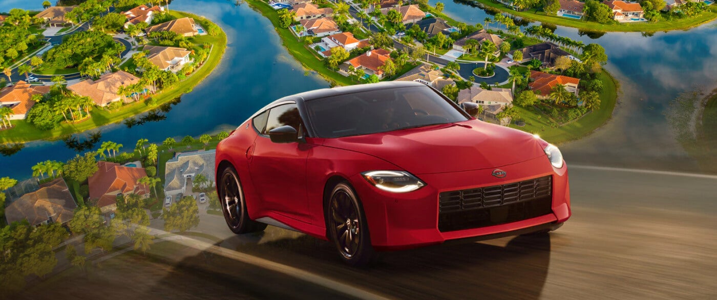 A red 2026 Nissan Z driving overlaid over an aerial vieww of Weston, FL.